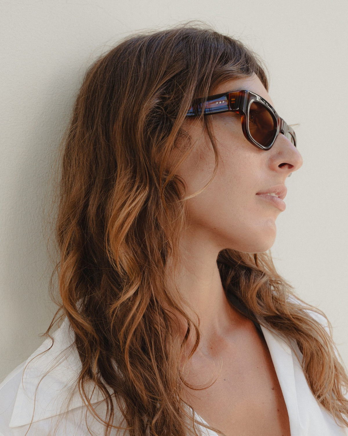 Woman wearing Massa amber tortoise wayfarer sunglasses with brown lenses, side profile