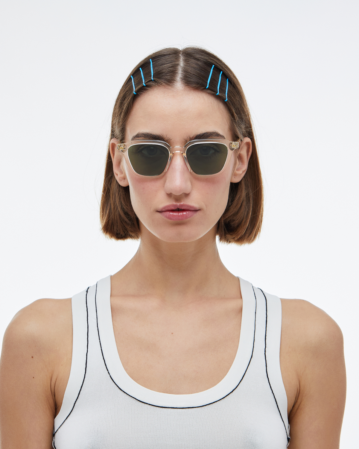 Woman wearing Yuzu clear rounded square sunglasses with green lenses