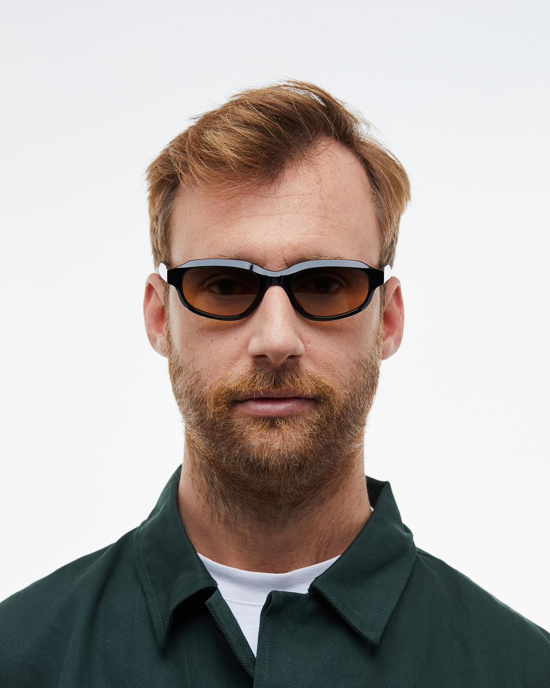 Man wearing Agaté black oval cat-eye sunglasses with gradient orange-to-blue lenses, look 3