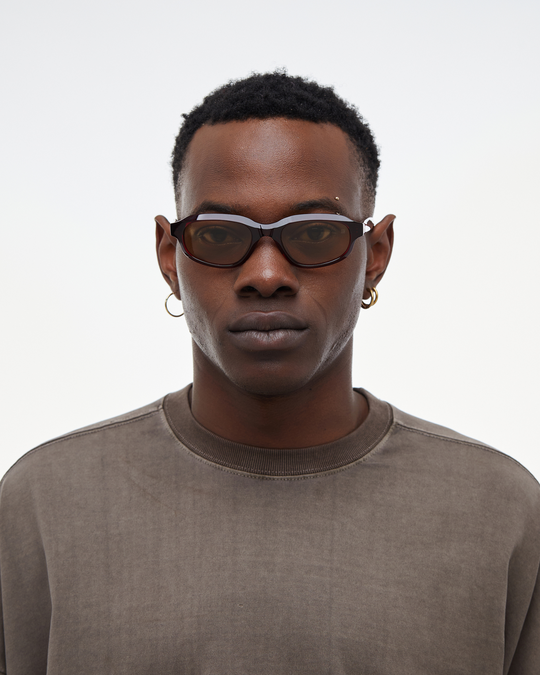 Man wearing Agaté burgundy oval cat-eye sunglasses with yellow lenses, look 2