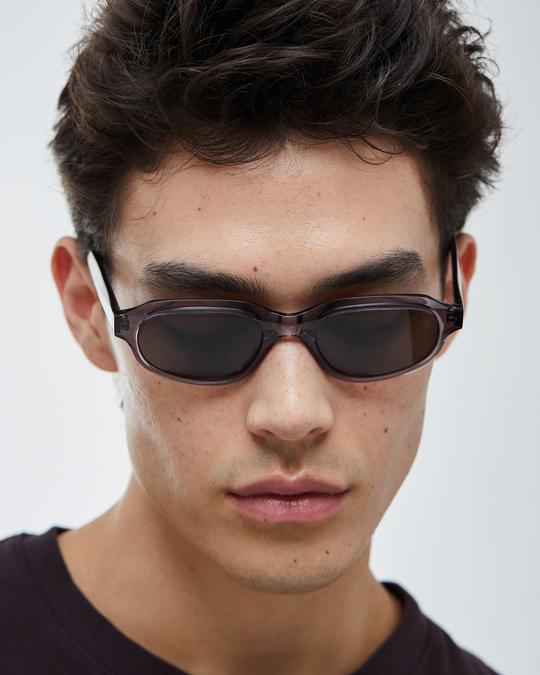 Man wearing Agaté gray oval cat-eye sunglasses with black lenses, look 2