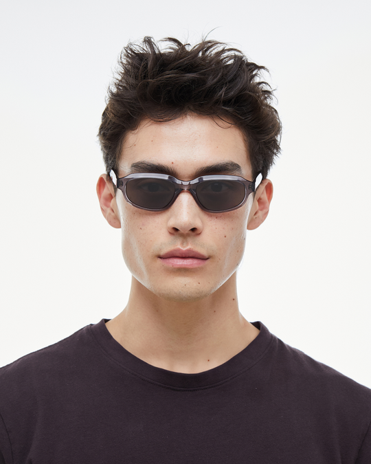 Man wearing Agaté gray oval cat-eye sunglasses with black lenses