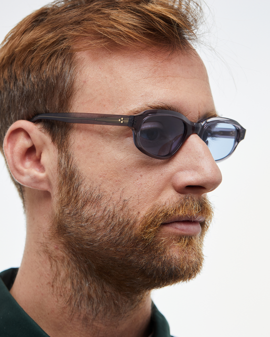 Man wearing Agaté gray oval cat-eye sunglasses with light blue lenses, look 3