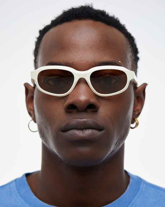 Man wearing Agaté white oval cat-eye sunglasses with brown lenses, look 2