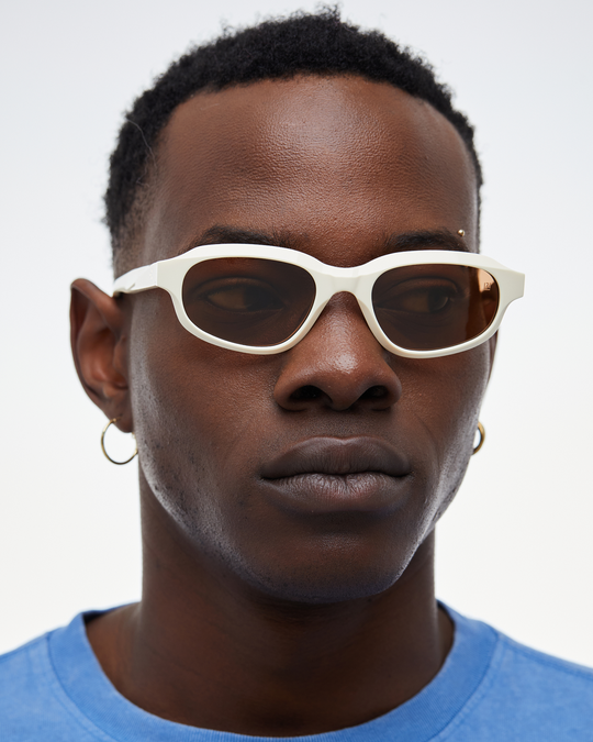 Man wearing Agaté white oval cat-eye sunglasses with brown lenses, look 3