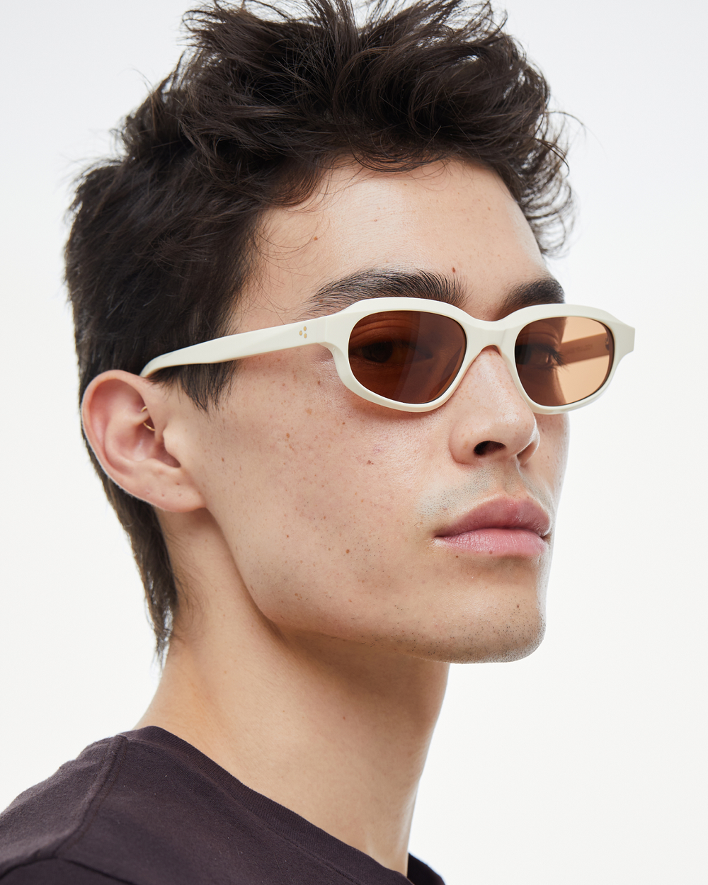 Man wearing Agaté white oval cat-eye sunglasses with brown lenses