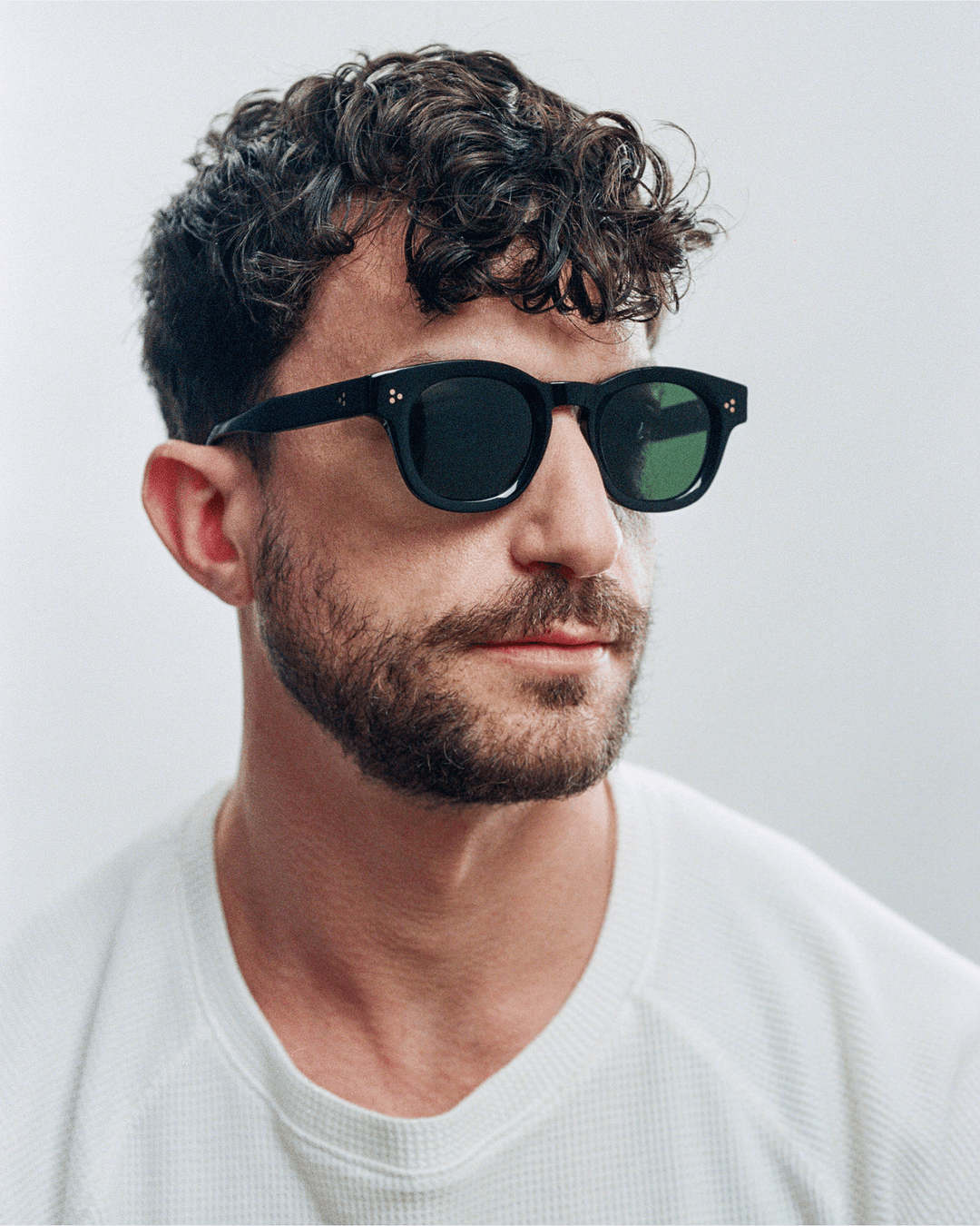 Man wearing Coco black round sunglasses with black lenses, look 2