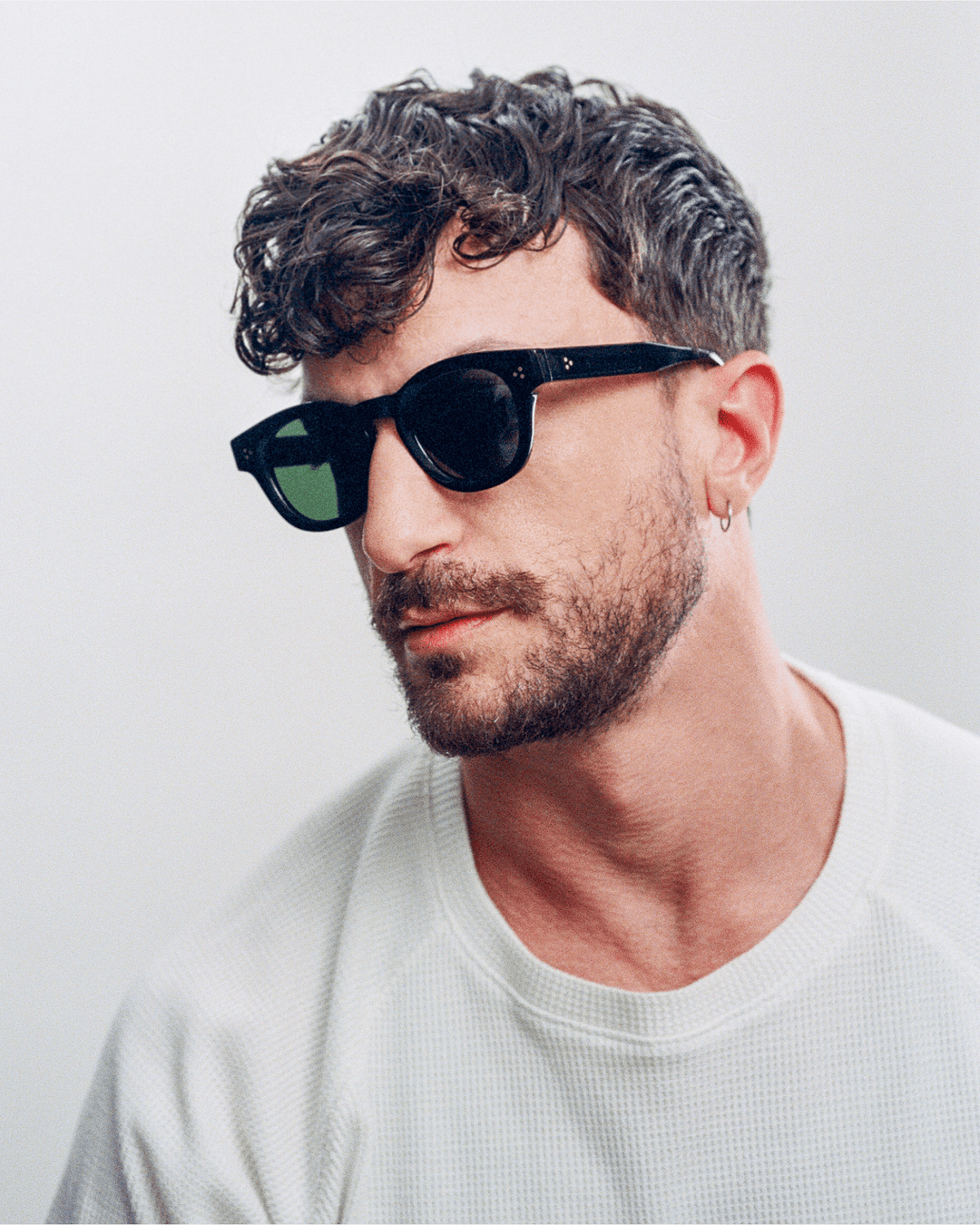Man wearing Coco black round sunglasses with black lenses