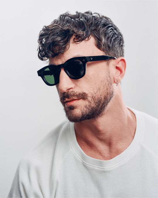 Man wearing Coco black round sunglasses with black lenses