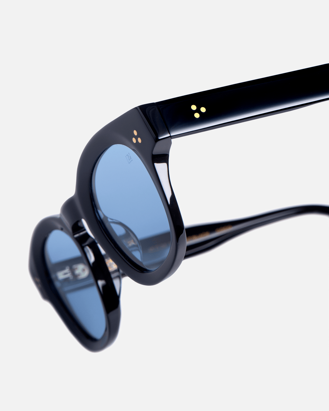 Coco black round sunglasses with light blue lenses, angled view