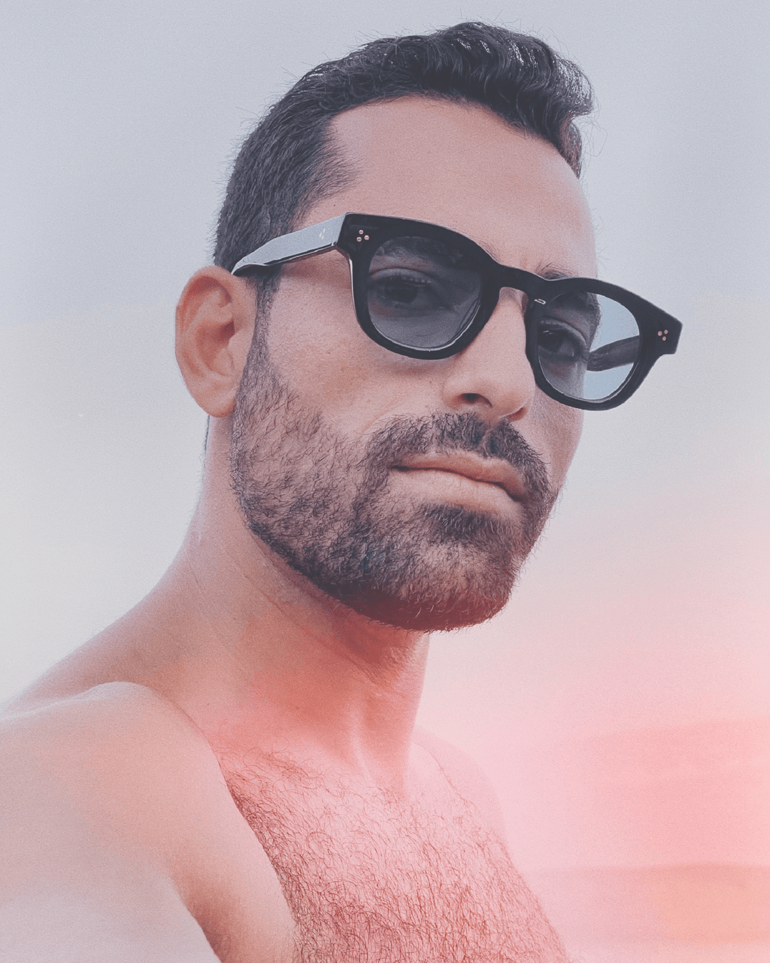 Man wearing Coco black round sunglasses with light blue lenses, look 3