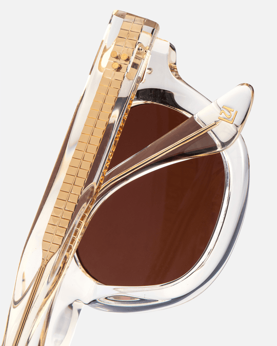 Coco clear round sunglasses with brown lenses, angled view