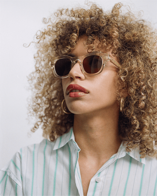 Woman wearing Coco clear round sunglasses with brown lenses, look 2