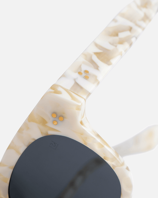 Coco white tortoise round sunglasses with green lenses, angled view
