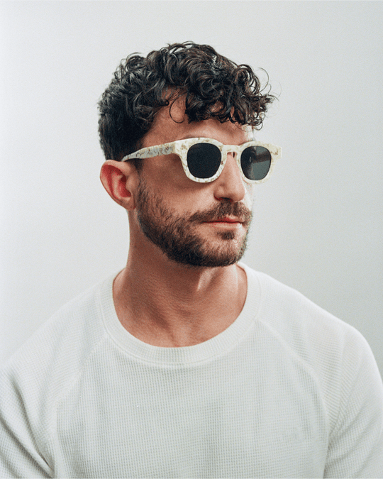 Man wearing Coco white tortoise round sunglasses with green lenses