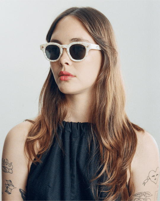 Woman wearing Coco white tortoise round sunglasses with green lenses, look 2