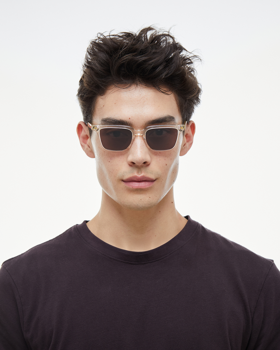 Man wearing Pepino clear rectangle sunglasses with brown lenses