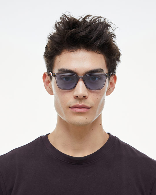 Man wearing Pepino gray rectangle sunglasses with light blue lenses