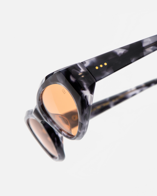 Pomé blue tortoise oval wrap sunglasses with orange lenses, angled view