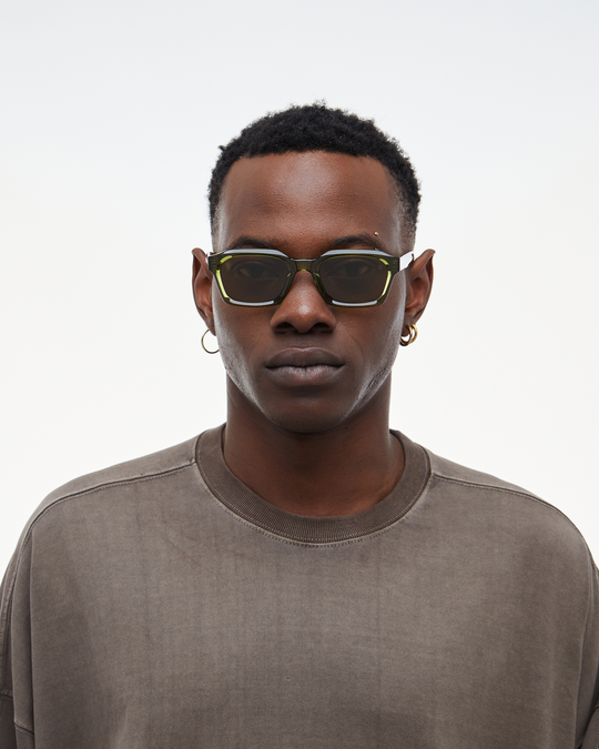 Man wearing Saguaro green square sunglasses with brown lenses