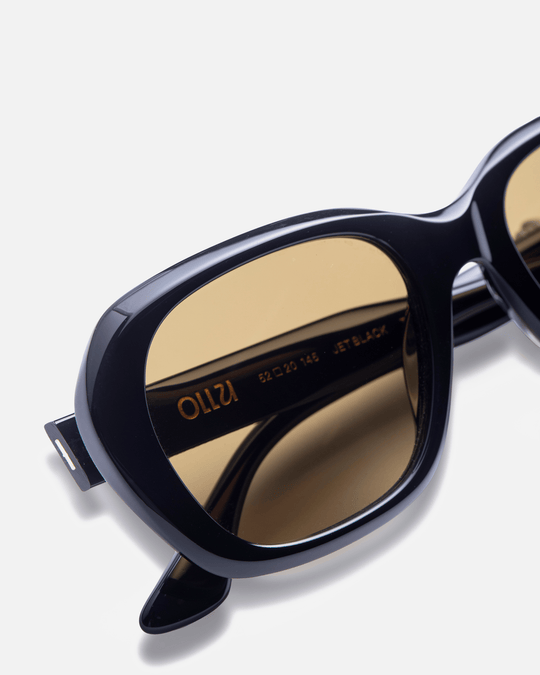 Tamar black round sunglasses with brown lenses, angled view
