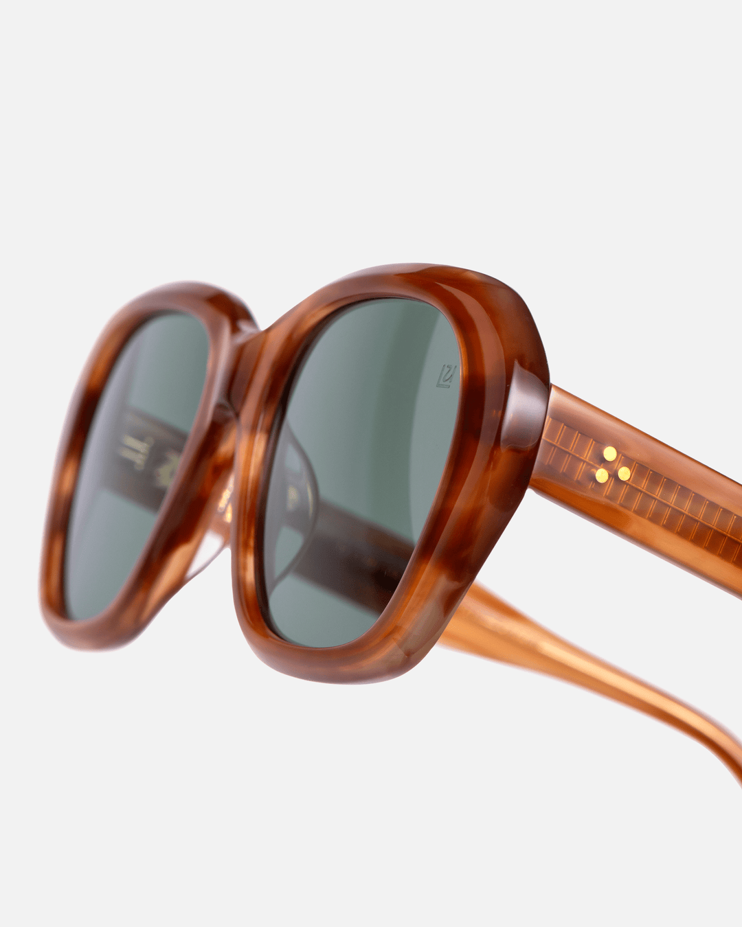 Tamar light brown round sunglasses with green lenses, angled view