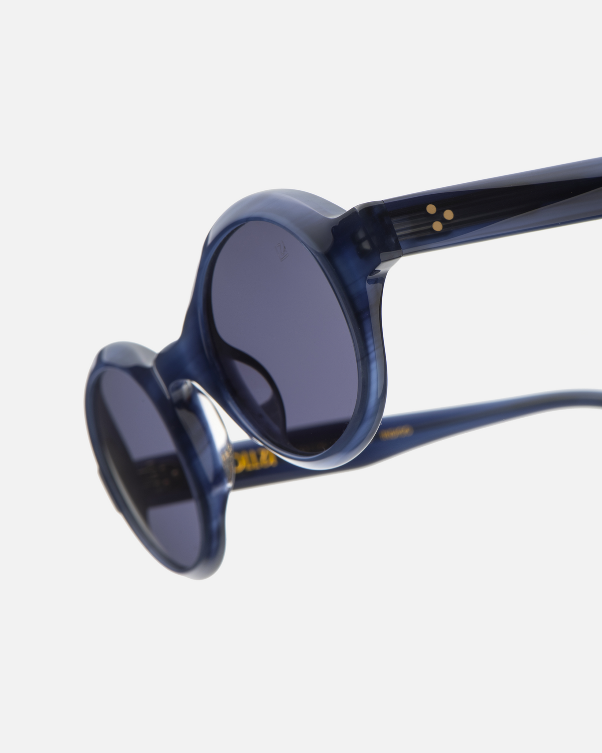 Umi navy narrow round sunglasses with dark purple lenses, angled view