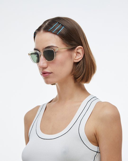 Woman wearing Yuzu clear rounded square sunglasses with green lenses, look 2