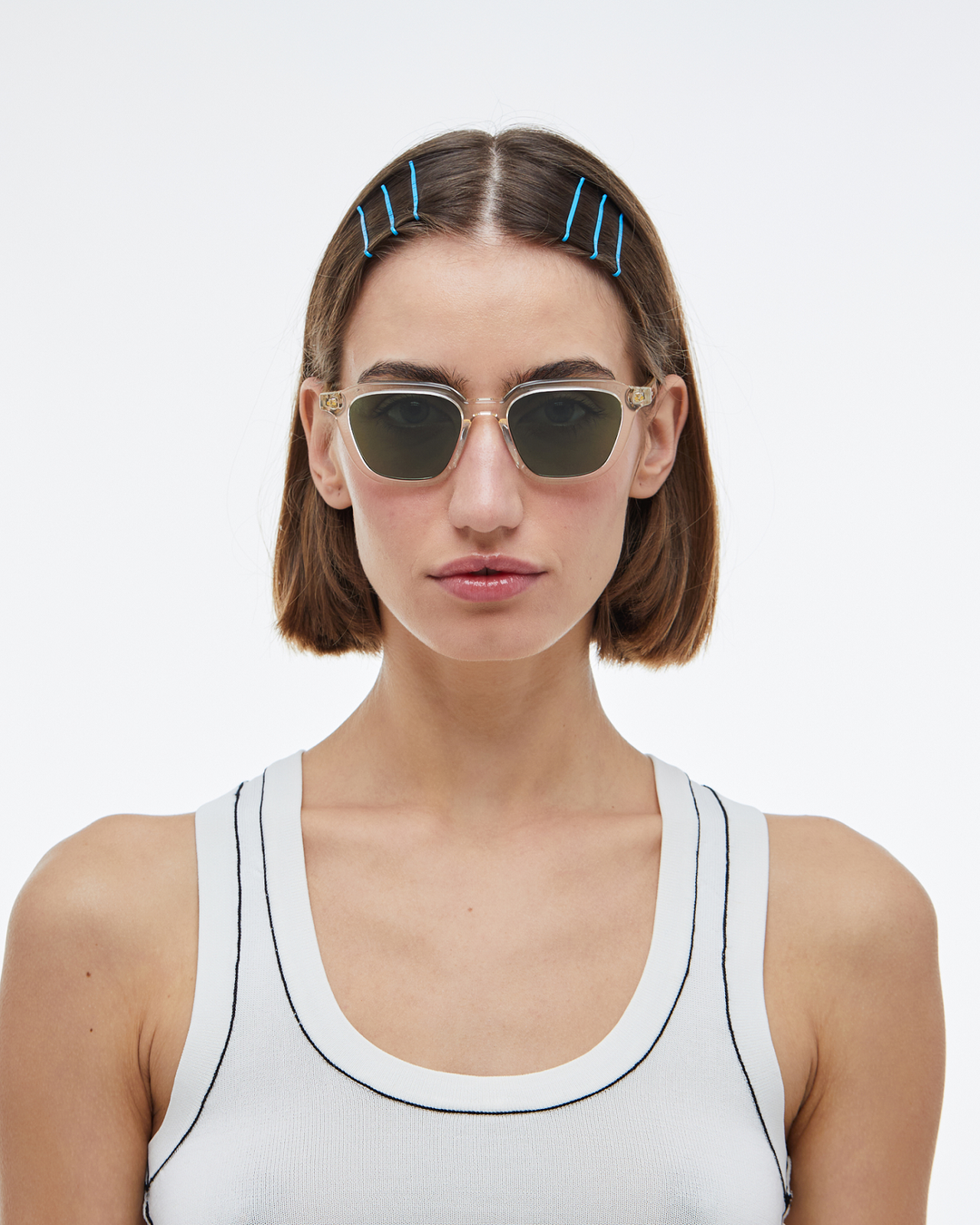 Woman wearing Yuzu clear rounded square sunglasses with green lenses