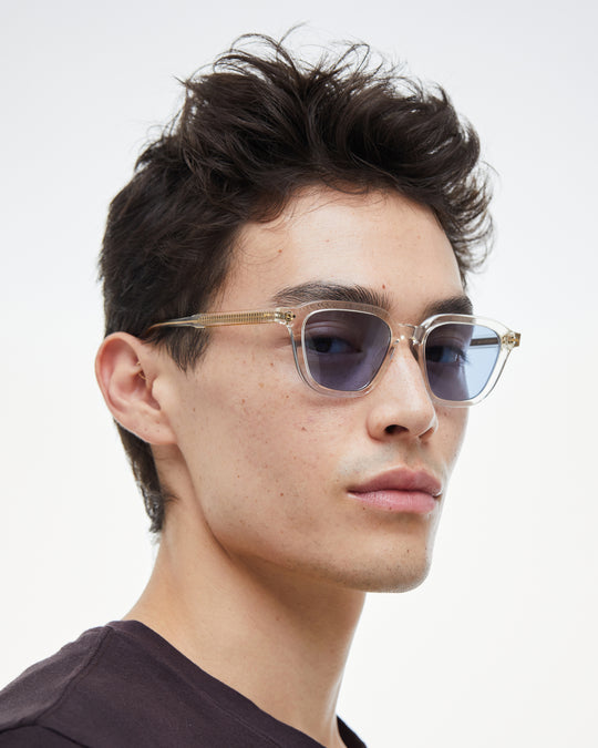 Man wearing Yuzu clear rounded square sunglasses with light blue lenses, look 2