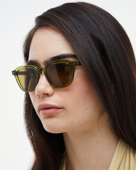 Woman wearing Yuzu green rounded square sunglasses with brown lenses, look 3