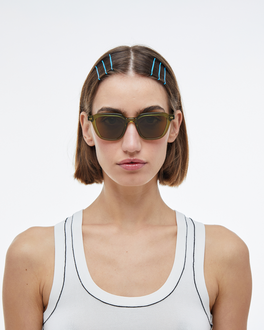 Woman wearing Yuzu green rounded square sunglasses with brown lenses