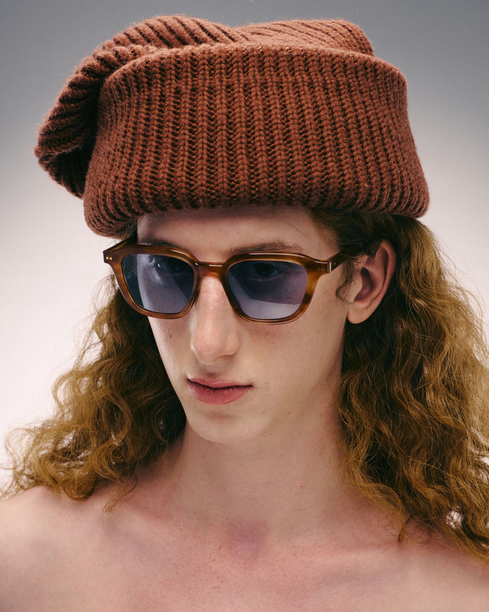 Man wearing Yuzu light brown rounded square sunglasses with light blue lenses